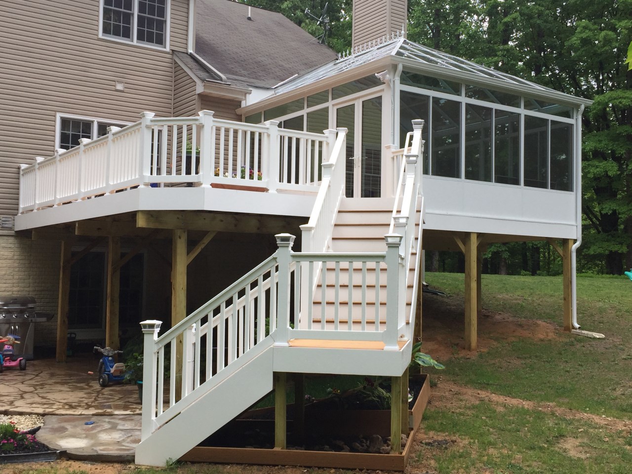 A newly installed wooden deck in a residential outdoor living space. | S&S Remodeling