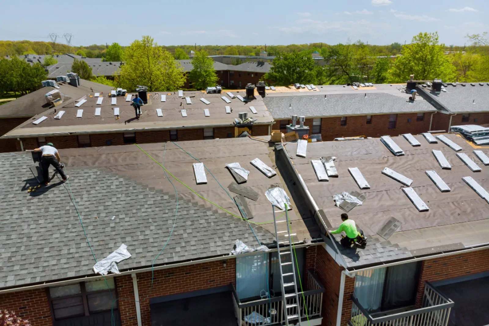 A newly installed asphalt roof on a multi-family building. | S&S Remodeling