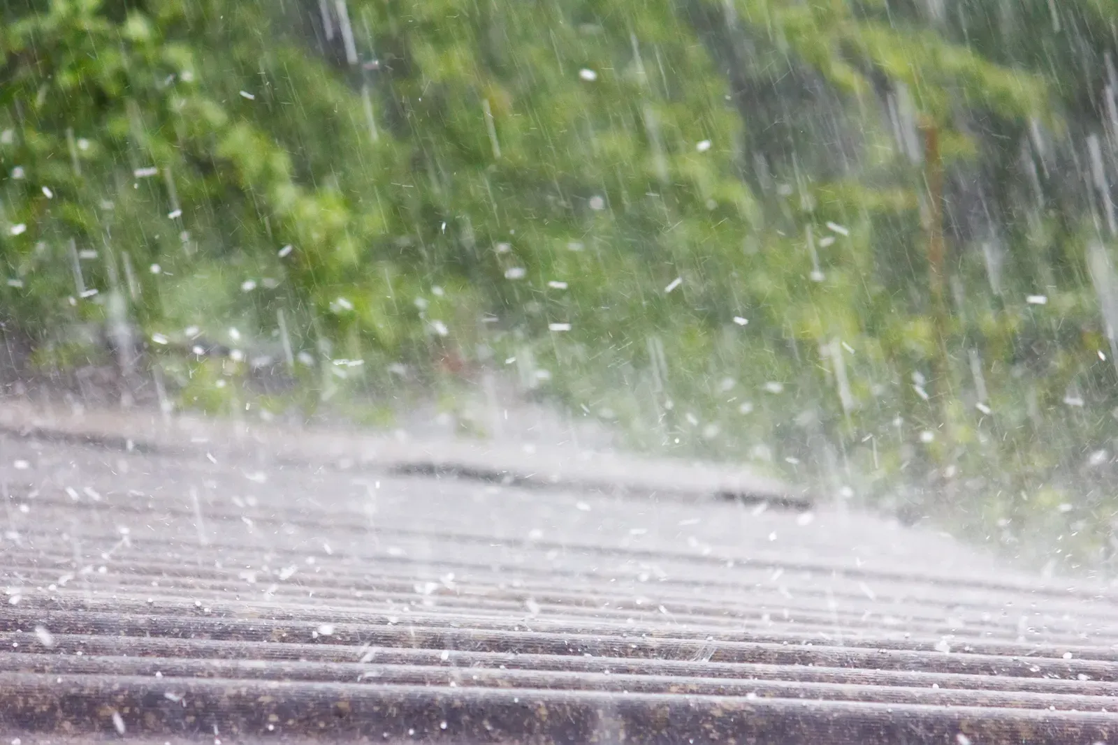 A damaged asphalt roof on a residential building after a storm. | S&S Remodeling