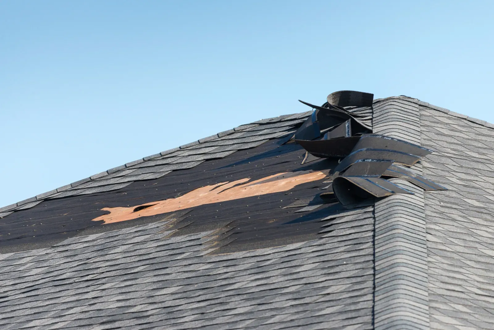 A damaged asphalt residential roof after a storm. | S&S Remodeling