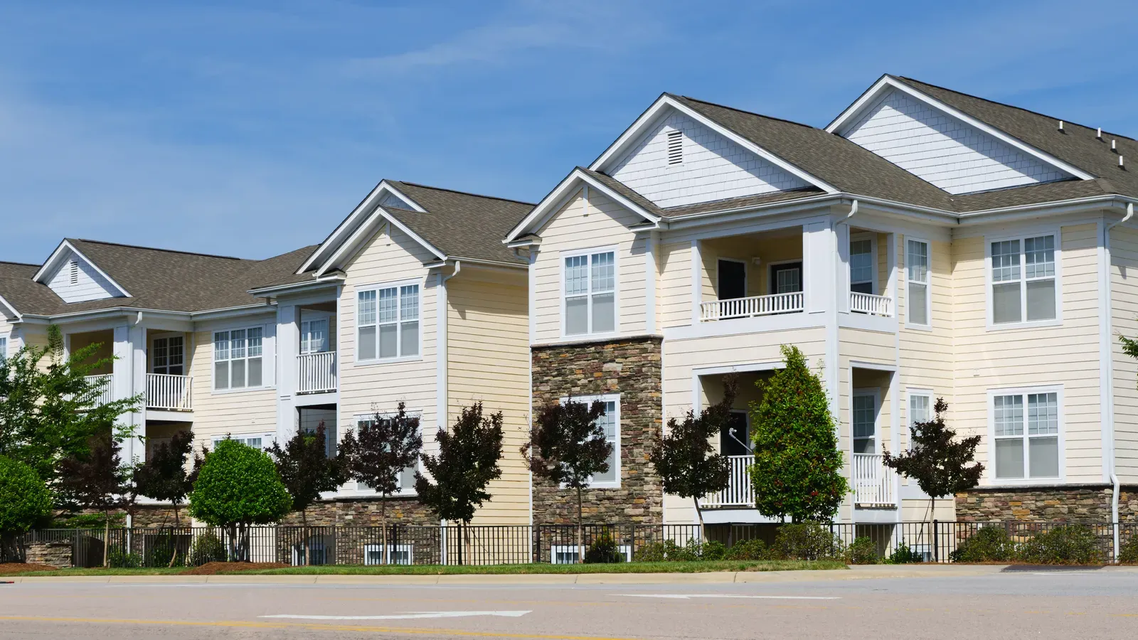 New vinyl siding and asphalt roof installation on multi-family building | S&S Remodeling