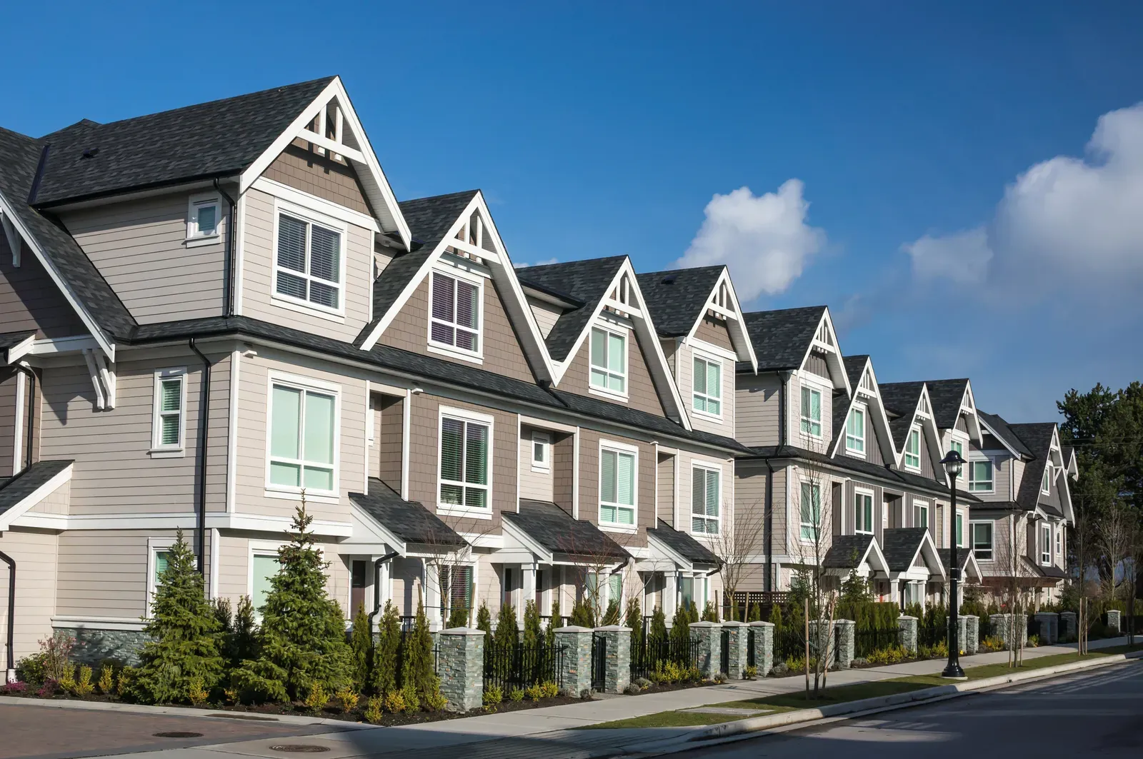 A new asphalt roof, vinyl siding, and aluminum gutter installation on a multi-family building. | S&S Remodeling