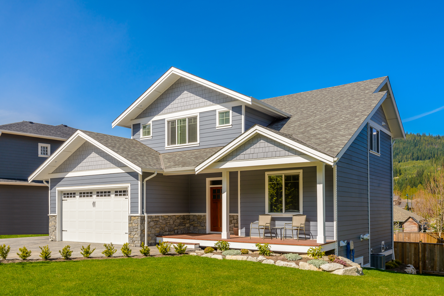 "Residential home with vinyl siding, asphalt roof, sliding windows, and gutter replacement" | S&S Remodeling