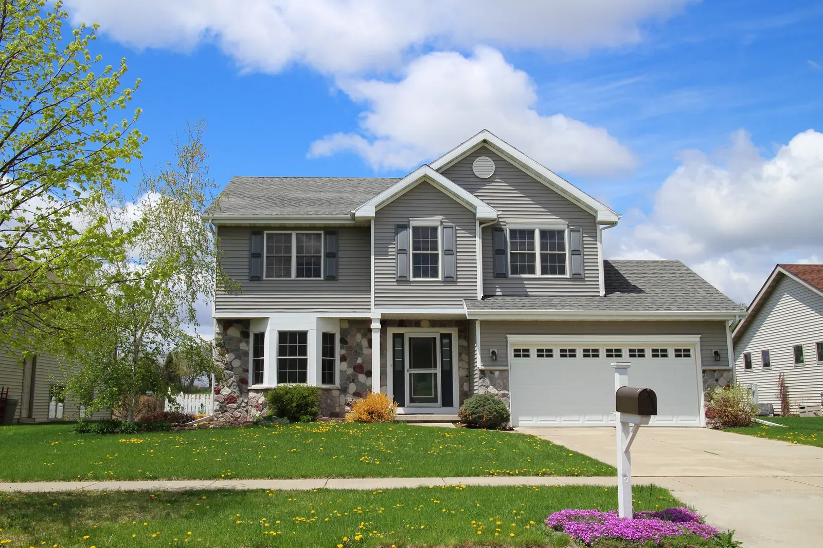 A professional installing new vinyl siding on a residential house exterior. | S&S Remodeling