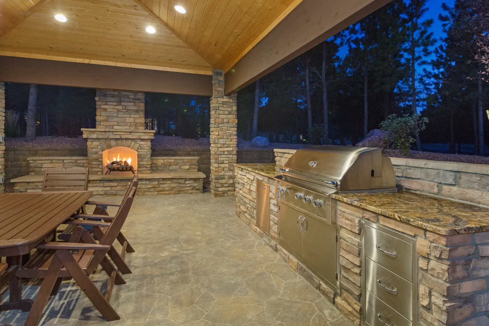 "Residential outdoor living remodel with stone patio and awning installation" | S&S Remodeling